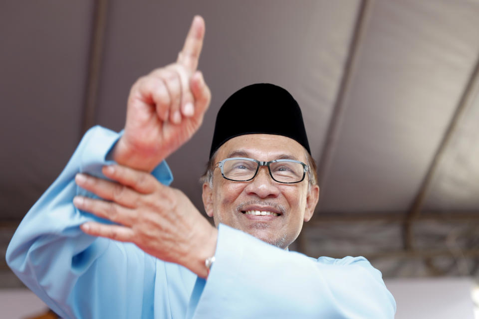 Malaysia's reform icon, Anwar Ibrahim, center, show No.1 sign for by-election nomination in Port Dickson, Malaysia, Saturday, Sept. 29, 2018. Anwar is contesting by-election scheduled on Oct. 13, in Port Dickson, a southern coastal town after a lawmaker vacated the seat to make way for Anwar Ibrahim's political comeback. (AP Photo/Vincent Thian)