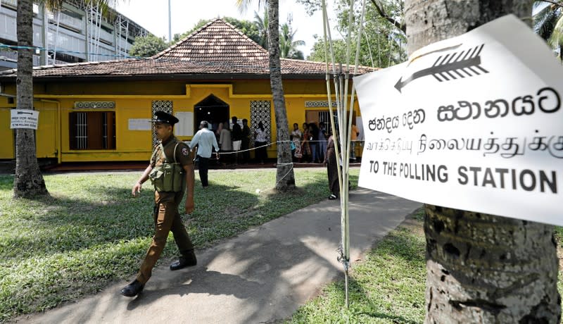 A police officer walks inside a polling station during the presidential election in Colombo