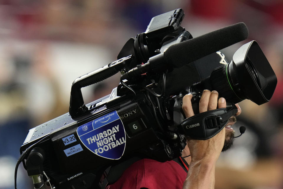 A Thursday Night Football cameraman is shown on the sidelines during the first half of an NFL football game between the Baltimore Ravens and Tampa Bay Buccaneers Thursday, Oct. 27, 2022, in Tampa, Fla. (AP Photo/Chris O'Meara)