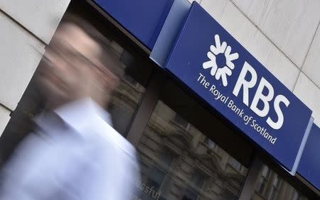 A man walks past a branch of The Royal Bank of Scotland (RBS) in central London August 27, 2014. REUTERS/Toby Melville