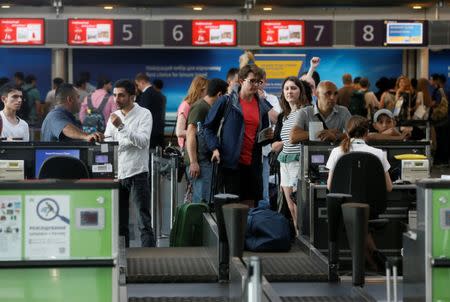 Passengers wait to have their luggage checked at the capital's main airport, Boryspil, outside Kiev, Ukraine, June 27, 2017. REUTERS/Valentyn Ogirenko