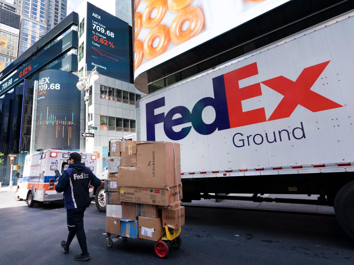 A FedEx driver delivers a cart of packages, Thursday, May 6, 2021, in New York.