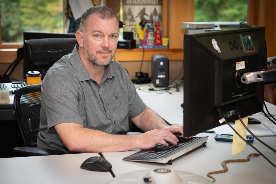 GIS Specialist Tom Colson sits at his workstation in the Twin Creeks Science and Education Center in Great Smoky Mountains National Park. Colson creates map layers and other informational tools that are key to guiding the work of many different kinds of researchers and park service staff.