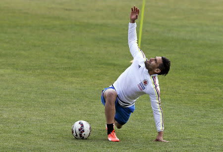 Radamel Falcao Garcia stretches during a training session in Santiago, June 23, 2015. REUTERS/Henry Romero