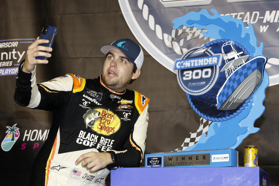 Noah Gragson poses with the trophy after winning the NASCAR Xfinity Series auto race at Homestead-Miami Speedway, Saturday, Oct. 22, 2022, in Homestead, Fla. (AP Photo/Terry Renna)