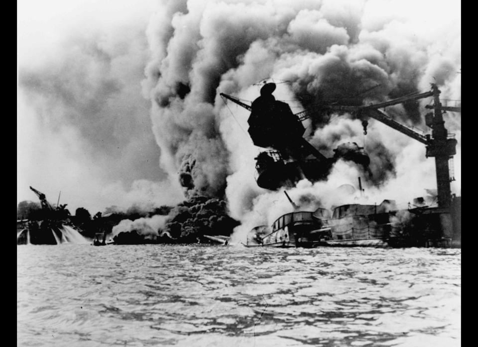 The USS Arizona is pictured in flames after the Japanese attack.