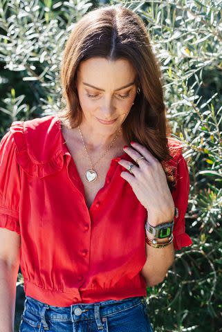 <p>Emily Young</p> Alliance of Moms founder Kelly Zajfen in the grief necklace she helped design
