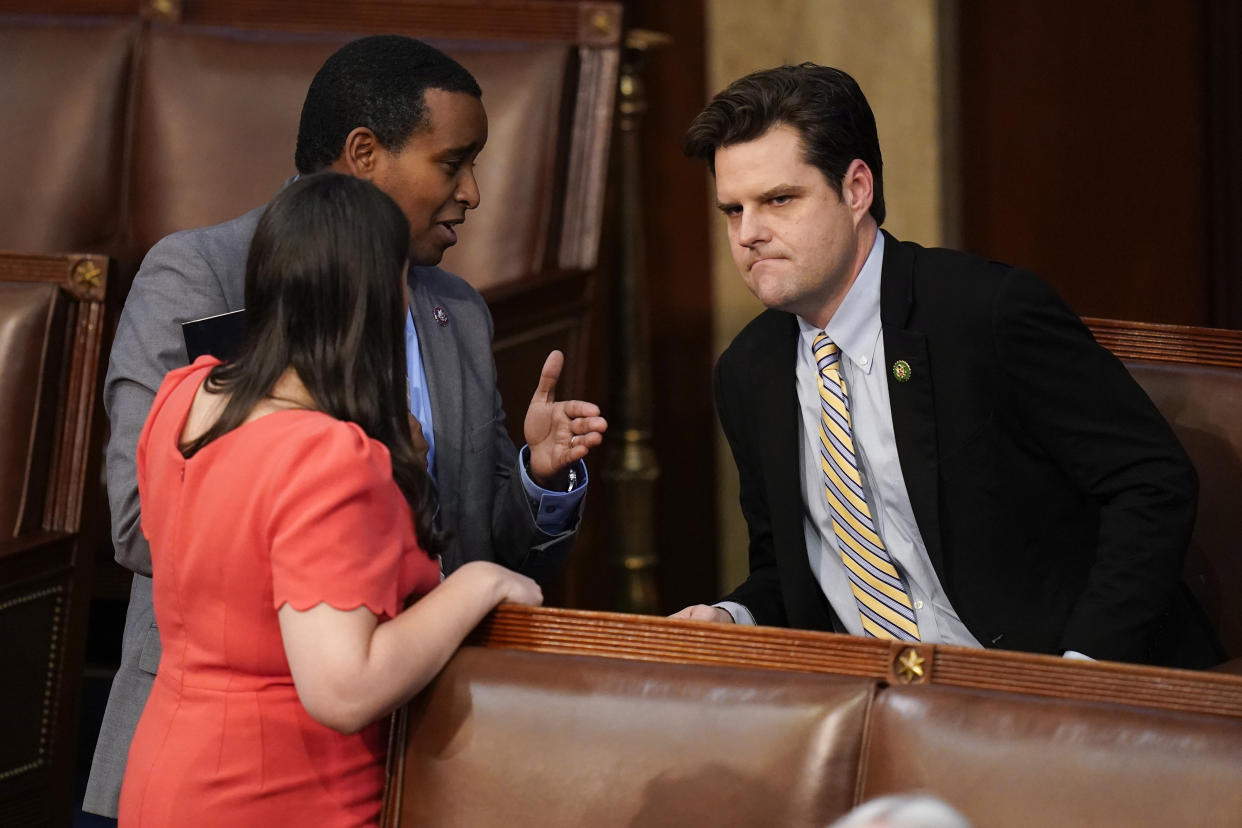 Rep. Joe Neguse, D-Colo., left, talks with Rep. Matt Gaetz, R-Fla., during the eleventh vote in the House chamber as the House meets for the third day to elect a speaker and convene the 118th Congress in Washington, Thursday, Jan. 5, 2023. (AP Photo/Alex Brandon)