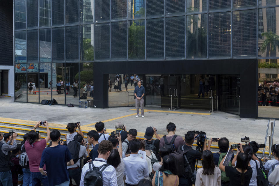 Chung Pui-kuen, the ex-chief editor of the now shuttered Stand News online outlet, stand before the media outside the district court, in Hong Kong on Thursday, Aug. 29, 2024. (AP Photo/Billy H.C. Kwok)