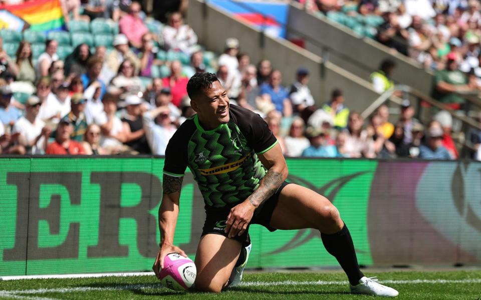 A pride flag can clearly be seen in the stands as Israel Folau scores for the World XV at Twickenham - Getty Images/David Rogers