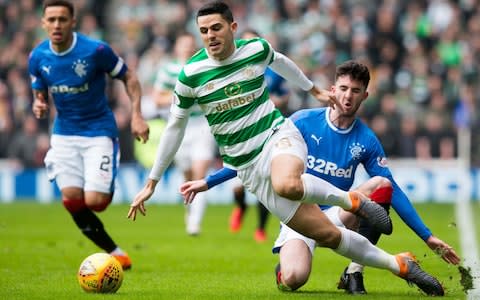Rangers Sean Goss (right) and Celtic's Tom Rogic battle for the ball during the Ladbrokes Scottish Premiership match at Ibrox Stadium - Credit: Jeff Holmes/PA Wire