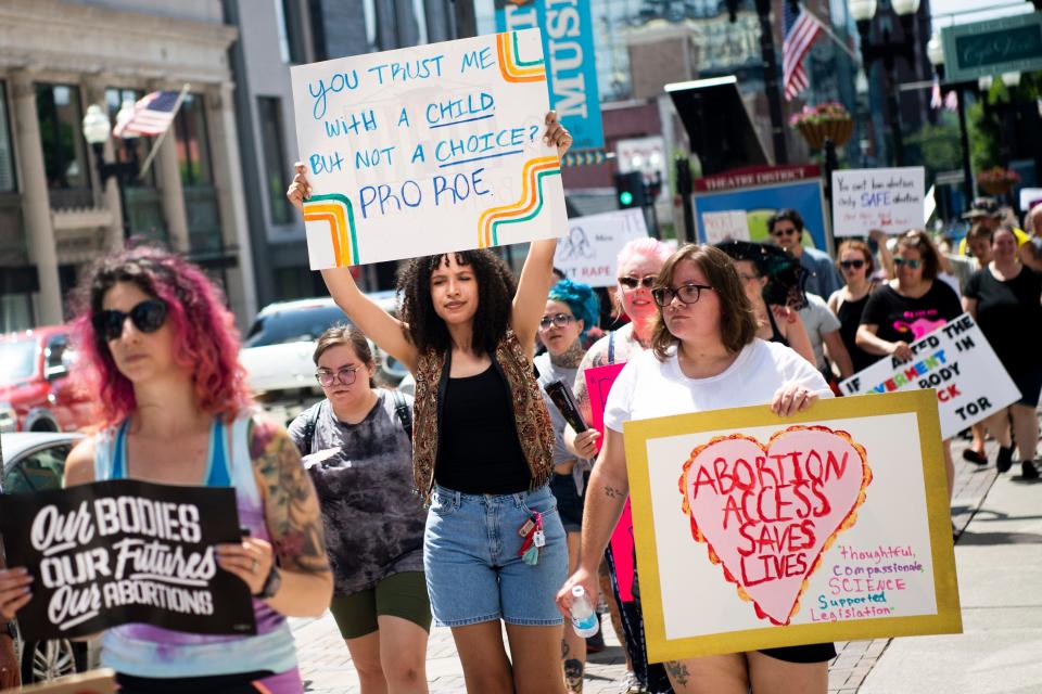 Demonstrators hold signs and chant together in support of abortion rights as they march along Gay Street in downtown Knoxville during the Bans Off Our Bodies March on July 6, 2022.