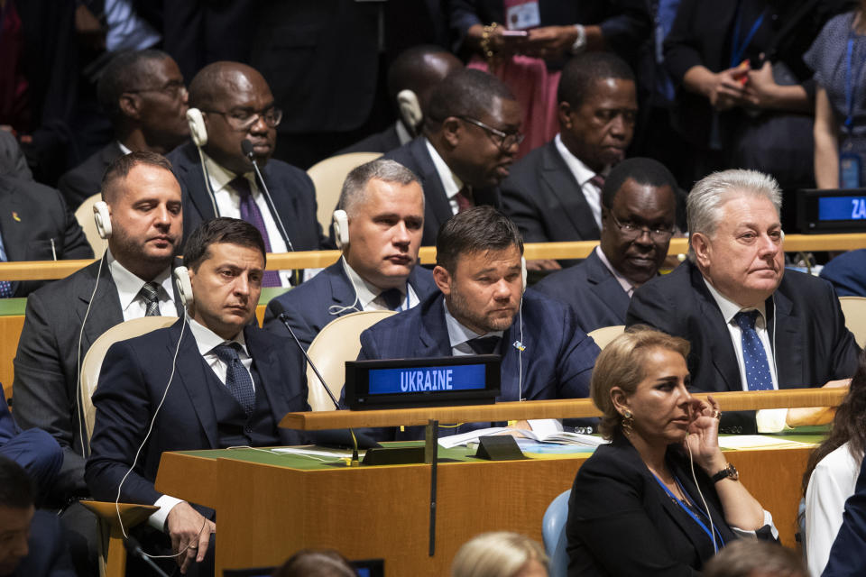 ADDS NAMES OF PRESIDENT ZELENSKY AND AMBASSADOR YELCHENKO - Delegates from Ukraine including President Volodymyr Zelensky, left, and Ambassador to U.N. Volodymyr Yelchenko, right, listen as U.S. President Donald Trump addresses the 74th session of the United Nations General Assembly at U.N. headquarters Tuesday, Sept. 24, 2019. (AP Photo/Mary Altaffer)