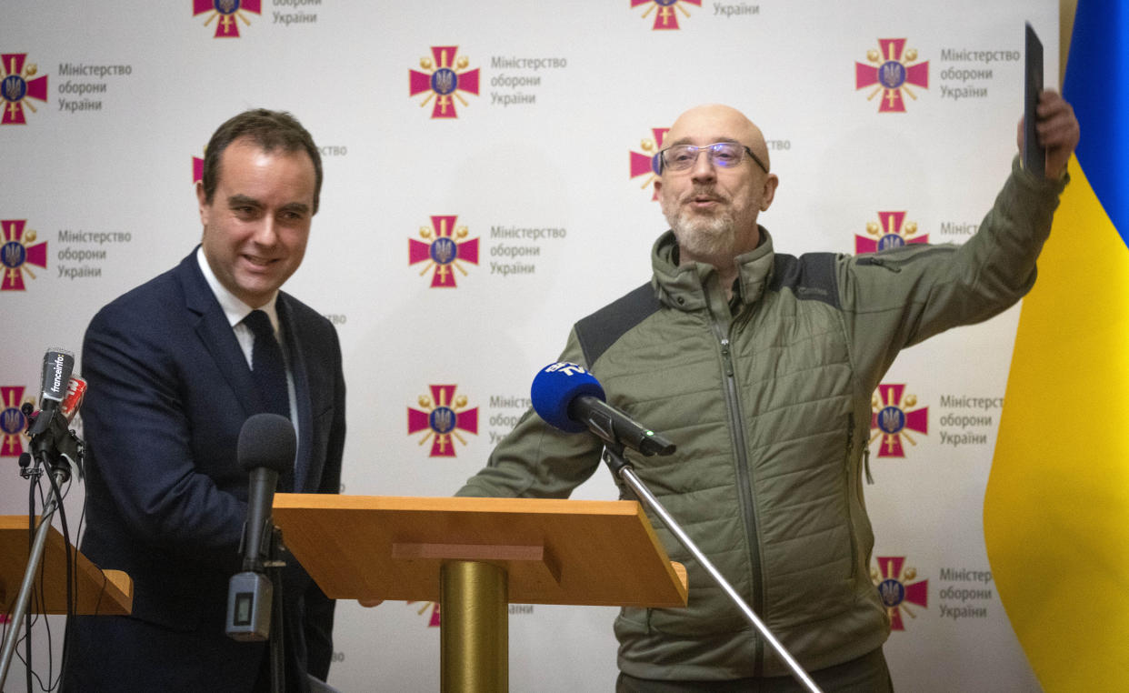 French Defense Minister Sebastien Lecornu, left, and his Ukrainian counterpart Oleksii Reznikov answer media questions at a joint press conference in Kyiv, Ukraine, Wednesday, Dec. 28, 2022. (AP Photo/Efrem Lukatsky)