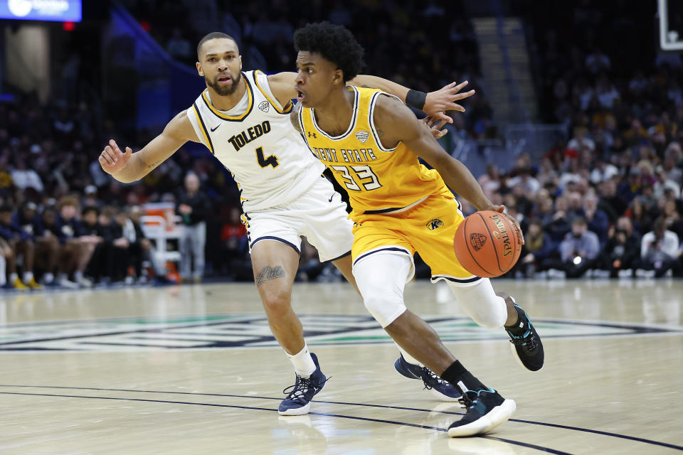 Kent State forward Miryne Thomas (33) drives against Toledo forward Setric Millner Jr. (4) during the first half of an NCAA college basketball game for the championship of the Mid-American Conference Tournament, Saturday, March 11, 2023, in Cleveland. (AP Photo/Ron Schwane)