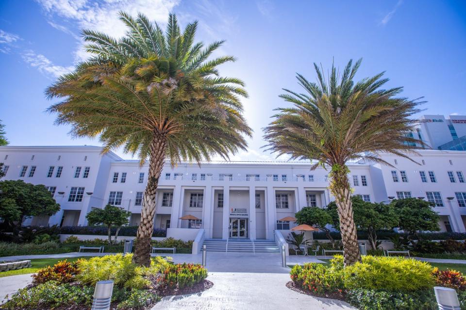 A white building with palm trees