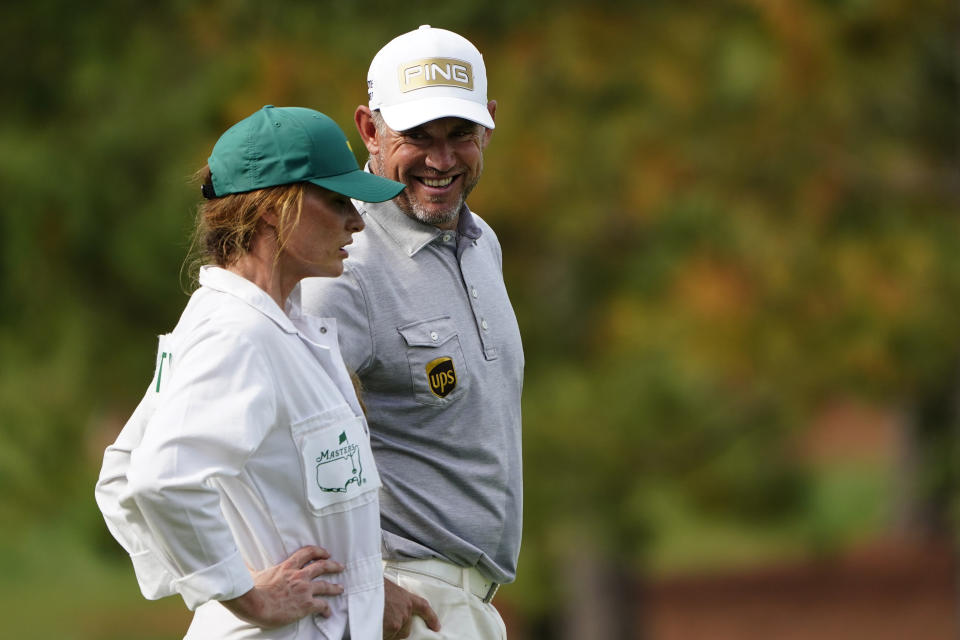 Lee Westwood, of England, talks to his caddie Helen Storey on the seventh hole during the first round of the Masters golf tournament Thursday, Nov. 12, 2020, in Augusta, Ga. (AP Photo/Matt Slocum)