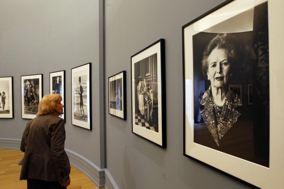 A visitor looks at the work of late fashion photographer Helmut Newton at the opening of his first retrospective in France at the Grand Palais museum, Paris, Friday, March 23, 2012. The exhibit, curated by his widow June Newton, contains some 250 pictures, many of which are provocative and erotically charged. His black-and-white photos were a mainstay of fashion magazines across the world for several decades, especially Vogue Paris. (AP Photo/Francois Mori)
