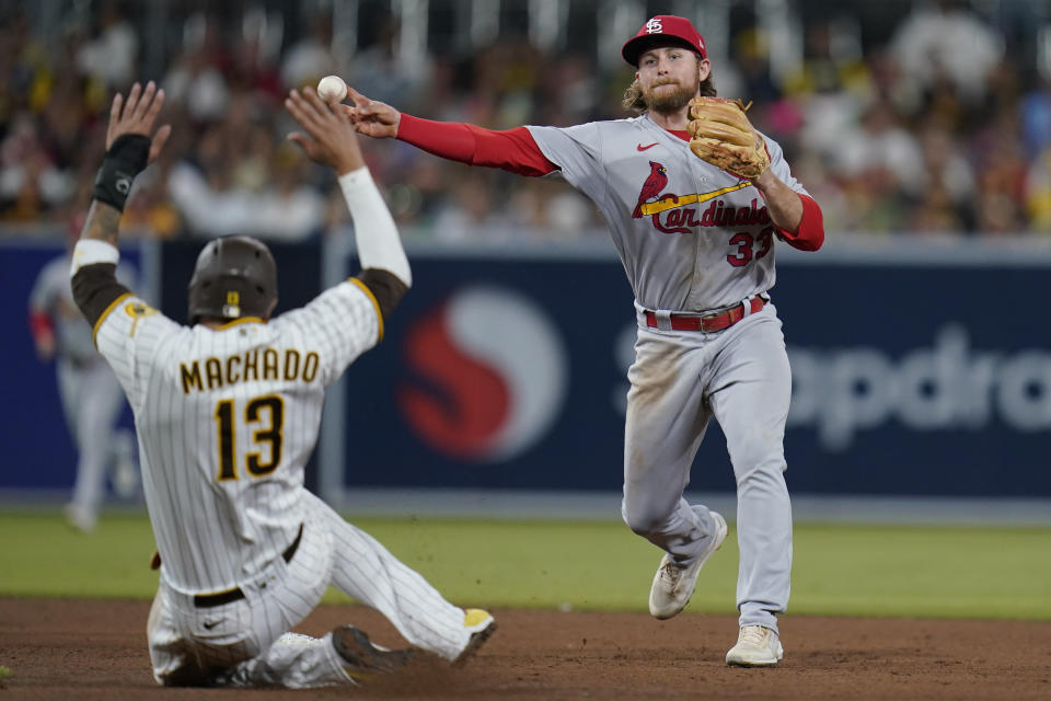 St. Louis Cardinals second baseman Brendan Donovan throws to first for the double play after forcing out San Diego Padres' Manny Machado during the fifth inning of a baseball game Tuesday, Sept. 20, 2022, in San Diego. Brandon Drury was out at first. (AP Photo/Gregory Bull)