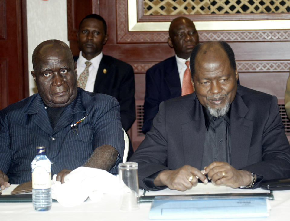 FILE - In this Jan. 11, 2006 file photo, African Forum members former Zambian Presidents, Kenneth Kaunda, left, and, Joachim Chissano of Mozambique, right, during a meeting in Nairobi, Kenya. Zambia’s first president Kenneth Kaunda has died at the age of 97, the country's president Edward Lungu announced Thursday June 17, 2021. (AP Photo/ Sayyid Azim, File)