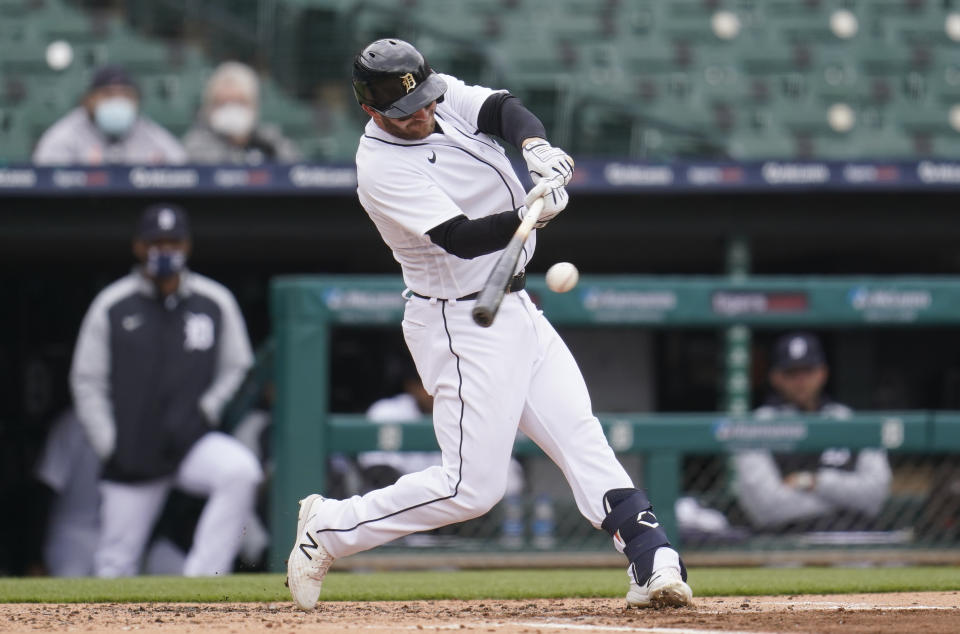 Detroit Tigers' Robbie Grossman hits a sacrifice fly against the Pittsburgh Pirates in the third inning during the first game of a doubleheader baseball game in Detroit, Wednesday, April 21, 2021. (AP Photo/Paul Sancya)