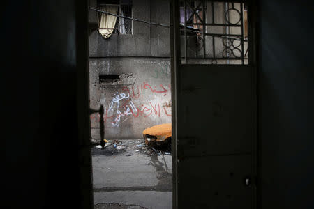 A rusted car is seen from inside an abandoned house in western Mosul, Iraq, April 12, 2017. REUTERS/Andres Martinez Casares