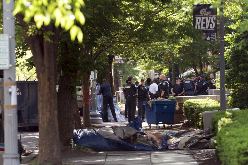 Workers carry student tents to a dump truck after police cleared a pro-Palestinian tent encampment at George Washington University early Wednesday and arrested demonstrators, Wednesday, May 8, 2024, in Washington. (AP Photo/Jose Luis Magana)