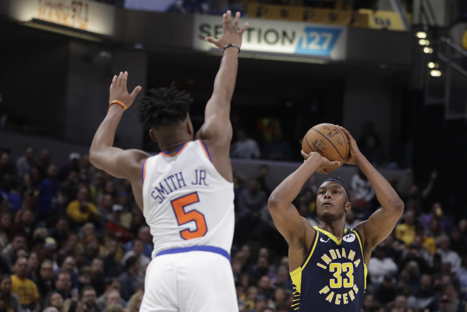 Indiana Pacers' Myles Turner (33) shoots against New York Knicks' Dennis Smith Jr. (5) during the second half of an NBA basketball game Saturday, Feb. 1, 2020, in Indianapolis. New York won 92-85. (AP Photo/Darron Cummings)