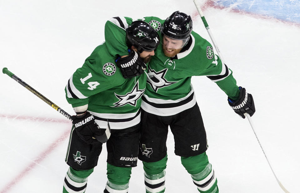 Dallas Stars' Jamie Benn (14) and Joe Pavelski (16) celebrate a goal against the Colorado Avalanche during first-period NHL Western Conference Stanley Cup playoff action in Edmonton, Alberta, Sunday, Aug. 30, 2020. (Jason Franson/The Canadian Press via AP)