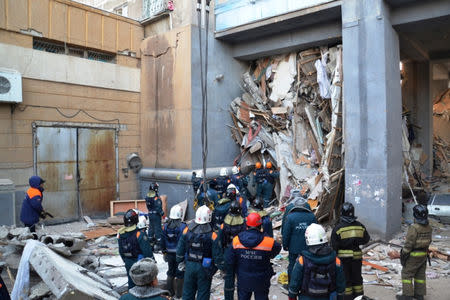 Russian Emergencies Ministry members work at the site of a partially collapsed apartment block in Magnitogorsk, Russia January 1, 2019. Russia's Ministry for Civil Defence, Emergencies and Elimination of Consequences of Natural Disasters/Handout via REUTERS