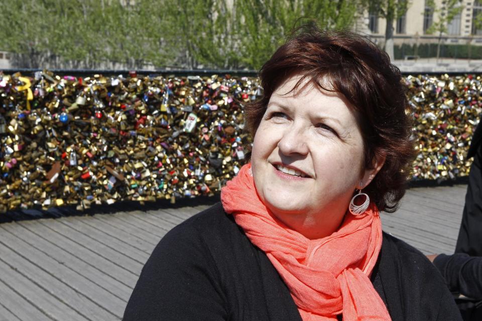 Lisa Taylor Huff from Hackettstown, NJ, speaks with an Associated Press reporter on the Pont des Arts in Paris, Wednesday April 16, 2014. A recent fad among travellers of hitching padlocks on bridges and at tourist attractions worldwide to symbolically immortalize their amorous attraction has swept up this reputed City of Love more than most. Now, two American-born women who live in Paris say they've had enough, launching a petition drive to try to get mostly laissez-faire city officials to step in and do something about what they call an unbearable eyesore in a majestic municipality. (AP Photo/Remy de la Mauviniere)