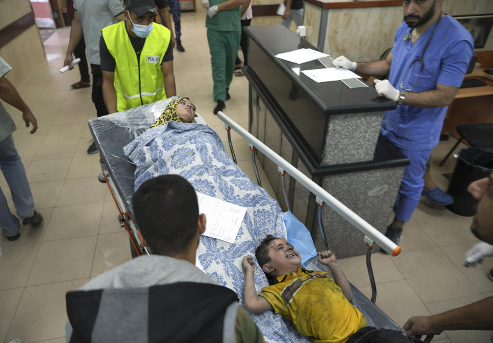 Palestinians wounded during Israeli bombardment are brought to a hospital in Deir al-Balah, southern Gaza Strip, Tuesday, Oct. 17, 2023. (AP Photo/Hatem Moussa)