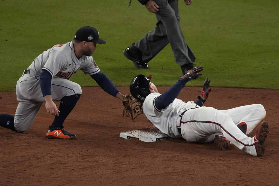 Atlanta Braves' Austin Riley is safe at second past Houston Astros second baseman Jose Altuve after a double during the sixth inning in Game 4 of baseball's World Series between the Houston Astros and the Atlanta Braves Saturday, Oct. 30, 2021, in Atlanta. (AP Photo/John Bazemore)