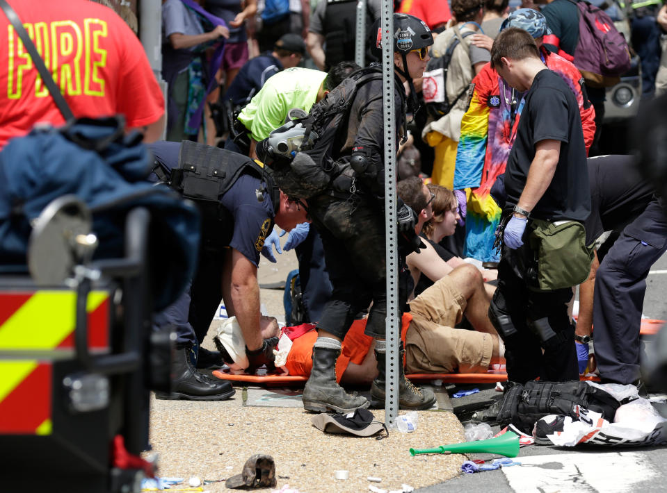 <p>Rescue workers assist people who were injured when a car drove through a group of counter protestors at the “Unite the Right” rally Charlottesville, Va., Aug. 12, 2017. (Photo: Joshua Roberts/Reuters) </p>