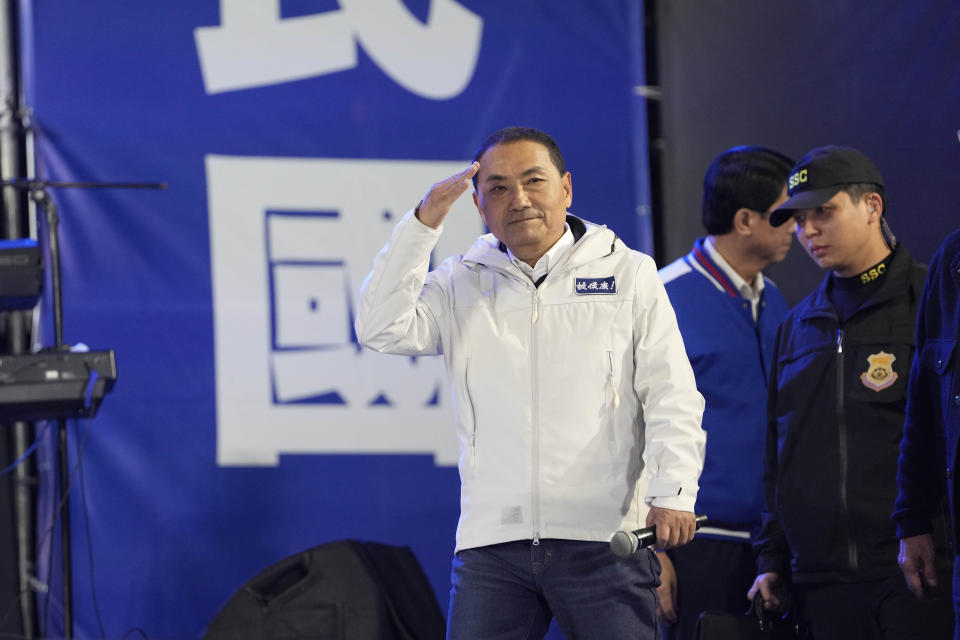 Kuomintang (KMT) presidential candidate Hou Yu-ih greets party supporters as votes are counted in New Taipei City, Taiwan, Saturday, Jan. 13, 2024. With half of votes counted, the candidate from Taiwan's ruling Democratic Progressive Party Lai Ching-te is leading in the race for the presidency according to local media reports. (AP Photo/Ng Han Guan)