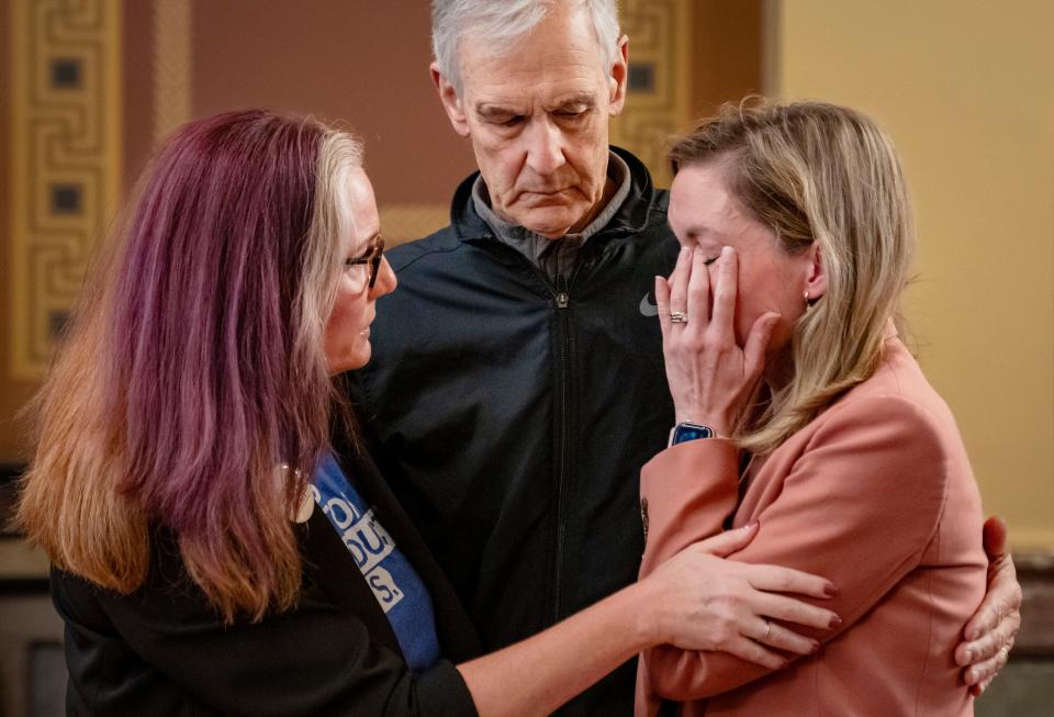 Abortion rights activists Dr. Francesca Turner, left, and Dr. William Newland comfort Dr. Emily Boevers during a press conference Friday at the Iowa Capitol after the Iowa Supreme Court cleared the way for Iowa's "fetal heartbeat" abortion ban to take effect.