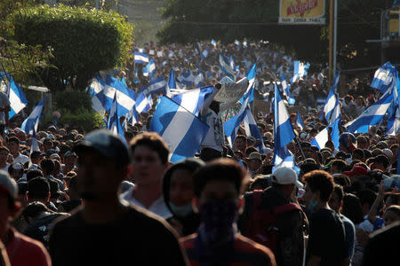 Demonstrators wave flags during a protest against police violence and the government of Nicaraguan President Daniel Ortega in Managua, Nicaragua April 23, 2018. REUTERS/Oswaldo Rivas