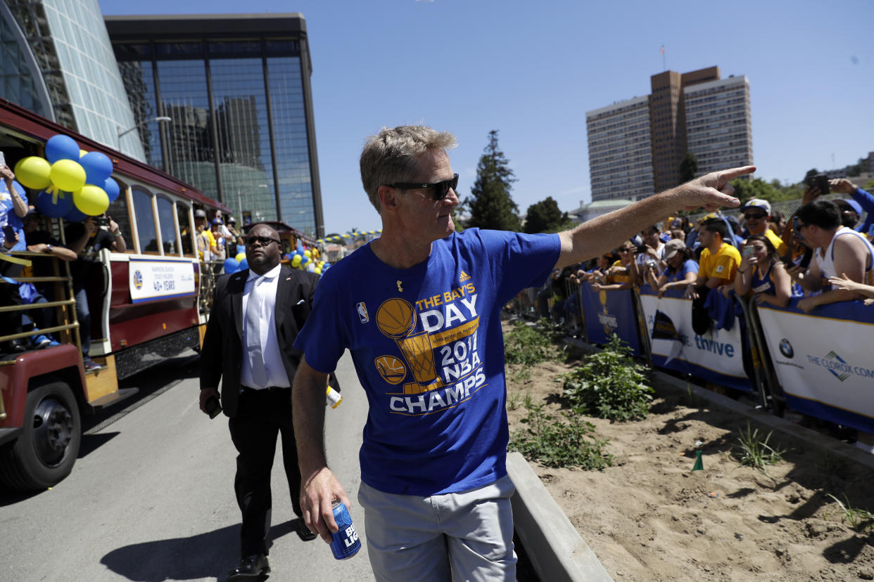 Warriors coach Steve Kerr points to the crowd during the team’s championship parade in June. (AP)