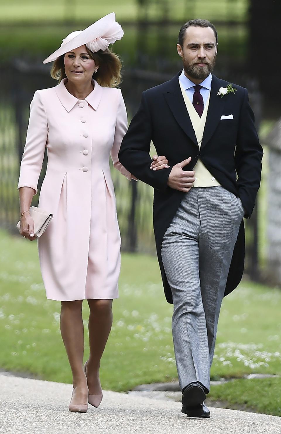 <p>The mother-of-the-bride <a rel="nofollow" href="https://uk.style.yahoo.com/carole-middleton-ultimate-mother-bride-daughter-pippas-wedding-125305333.html" data-ylk="slk:chose a pastel pink coat dress;elm:context_link;itc:0;sec:content-canvas;outcm:mb_qualified_link;_E:mb_qualified_link;ct:story;" class="link  yahoo-link">chose a pastel pink coat dress</a> by Catherine Walker with a matching wide-brimmed hat. The ensemble looked pretty similar to the one she wore to Kate’s 2011 wedding to Prince William. (Photo: AP)<i><br></i> </p>