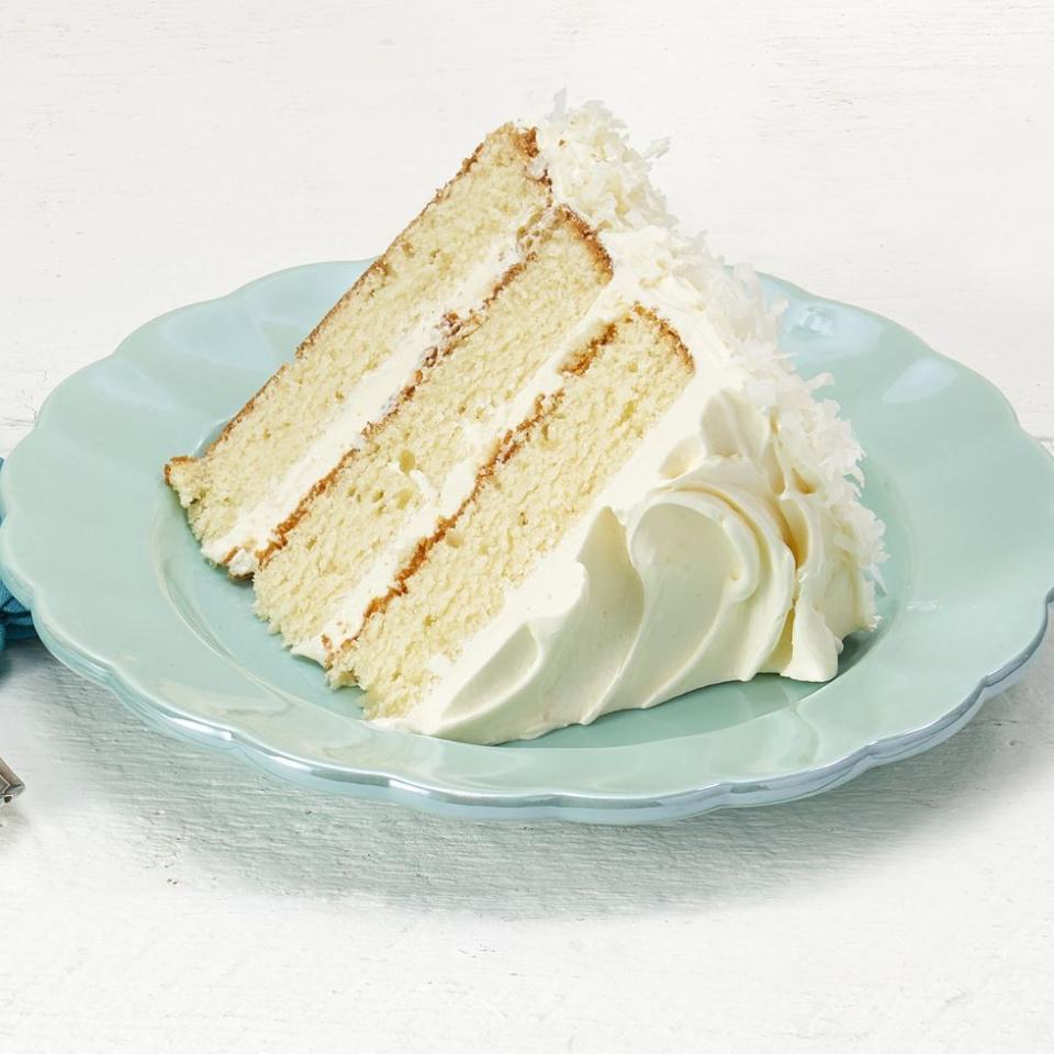 coconut layer cake slice on light blue plate
