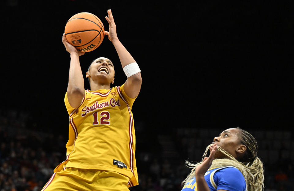 FILE - Southern California guard JuJu Watkins (12) shoots against UCLA guard Charisma Osborne during the second half of an NCAA college basketball game in the semifinals of the Pac-12 women's tournament Friday, March 8, 2024, in Las Vegas. Watkins selected to The Associated Press All-America women’s NCAA college basketball first team, Wednesday, March 20, 2024. (AP Photo/David Becker, File)