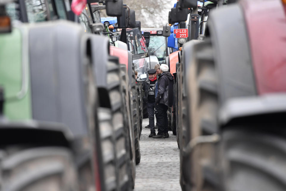 Farmers with their tractors block traffic on a road in the center of Brussels, during a demonstration, Friday, March 3, 2023. Hundreds of tractors driven by angry farmers protesting a plan to cut nitrate levels drove into Belgium's capital city on Friday causing major traffic disruption. (AP Photo/Geert Vanden Wijngaert)