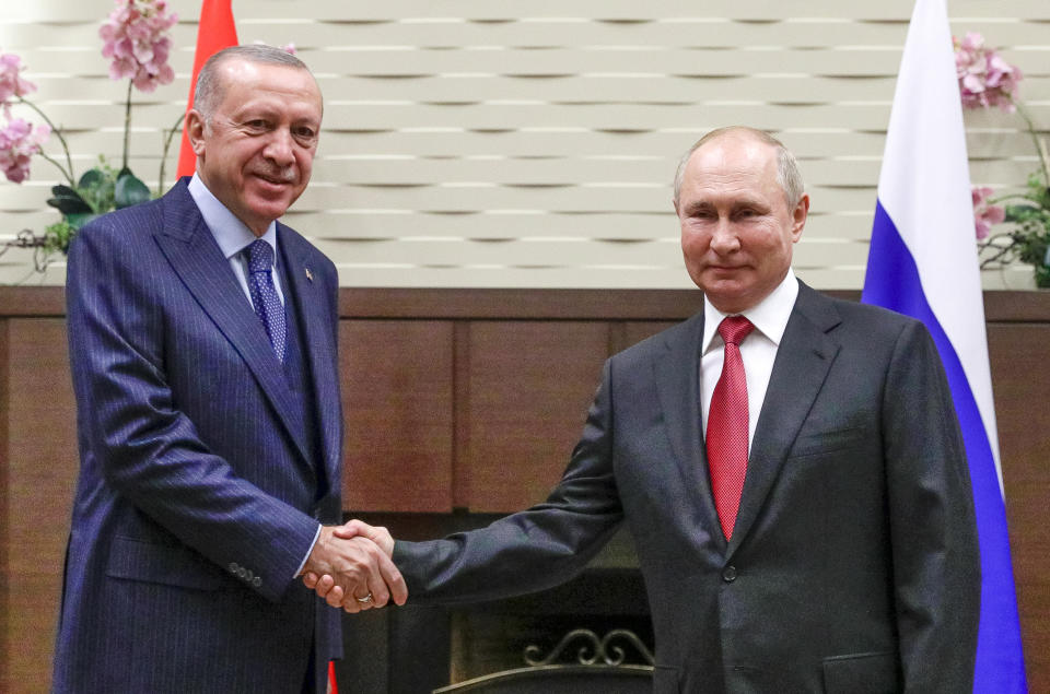 Russian President Vladimir Putin, right, and Turkish President Recep Tayyip Erdogan shake hands during their meeting in the Bocharov Ruchei residence in the Black Sea resort of Sochi, Russia, Wednesday, Sept. 29, 2021. (Vladimir Smirnov, Sputnik, Kremlin Pool Photo via AP)