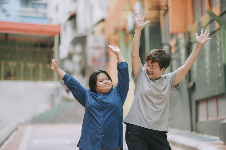 Two people dancing on the street