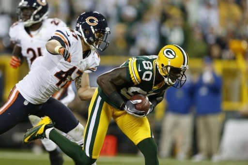 Donald Driver of the Green Bay Packers catches a 26-yard touchdown pass behind Chris Conte of the Chicago Bears during the second half of the game at Lambeau Field on September 13 in Green Bay, Wisconsin. The packers won 23-10