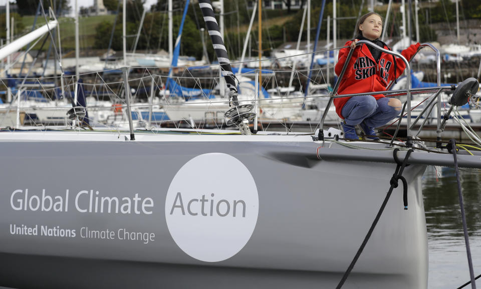 Greta Thunberg looks up as she poses for a picture on the boat Malizia as it is moored in Plymouth, England Tuesday, Aug. 13, 2019. Greta Thunberg, the 16-year-old climate change activist who has inspired student protests around the world, is heading to the United States this week - in a sailboat. (AP Photo/Kirsty Wigglesworth)