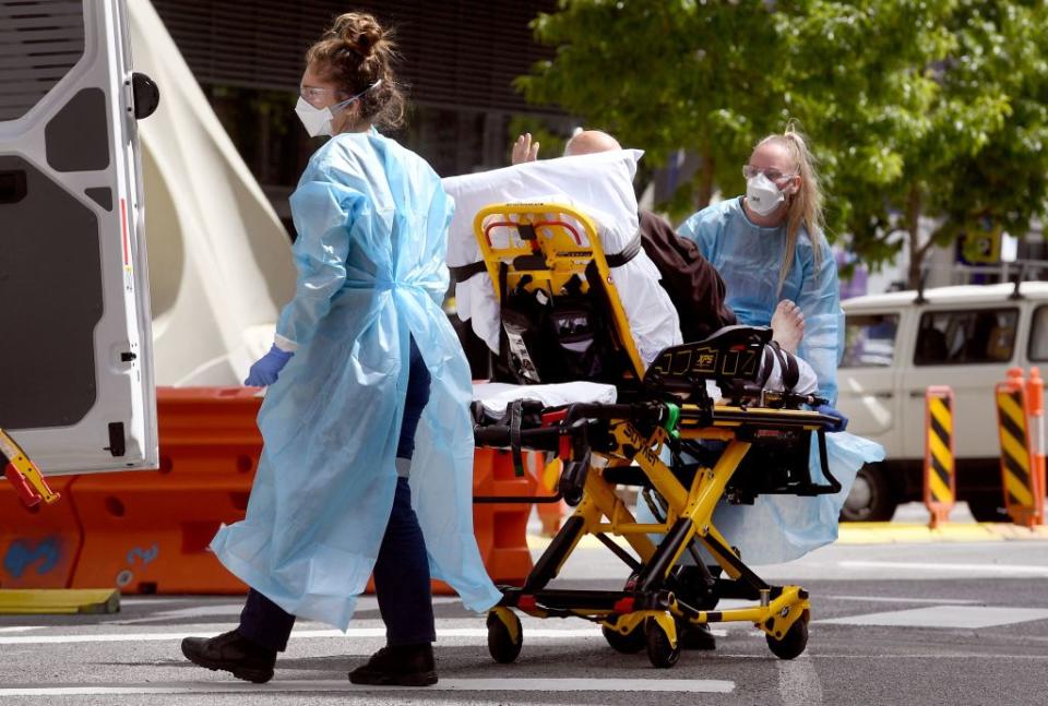 Medical staff transport a patient from the Royal Melbourne Hospital in Melbourne.