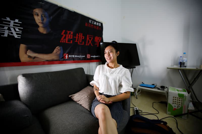 Prince Wong sits beneath a large campaign banner in her campaign office in an industrial building in the Tsuen Wan district of Hong Kong