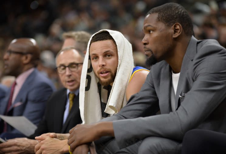 The Warriors are on fire and Kevin Durant is still wearing a suit with a t-shirt. (AP)