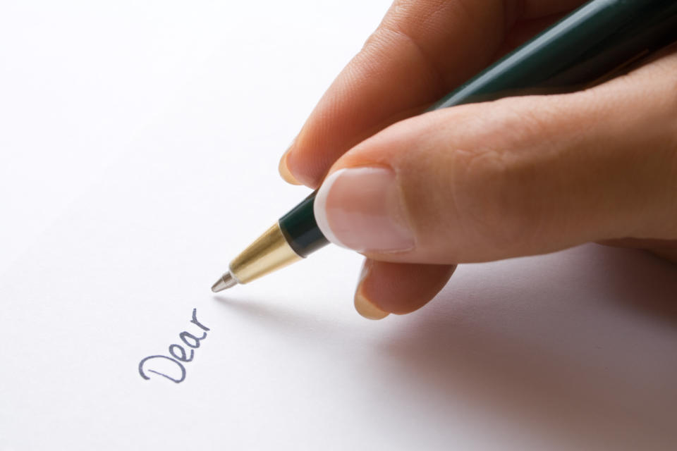 A person starting a letter with "Dear"